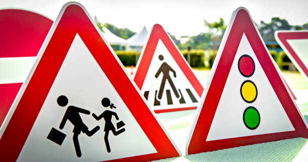 Pedestrian crossing mandatory sign set outside on the display with other sign boards for educational purposes.